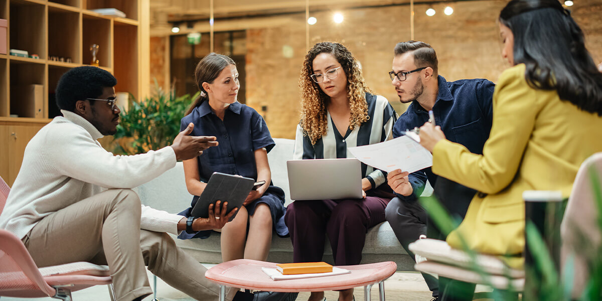 Team members engaged in a structured group discussion during a workplace collaboration workshop